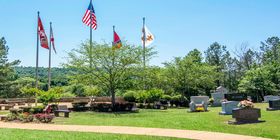Cemetery grounds with estate areas and flags.