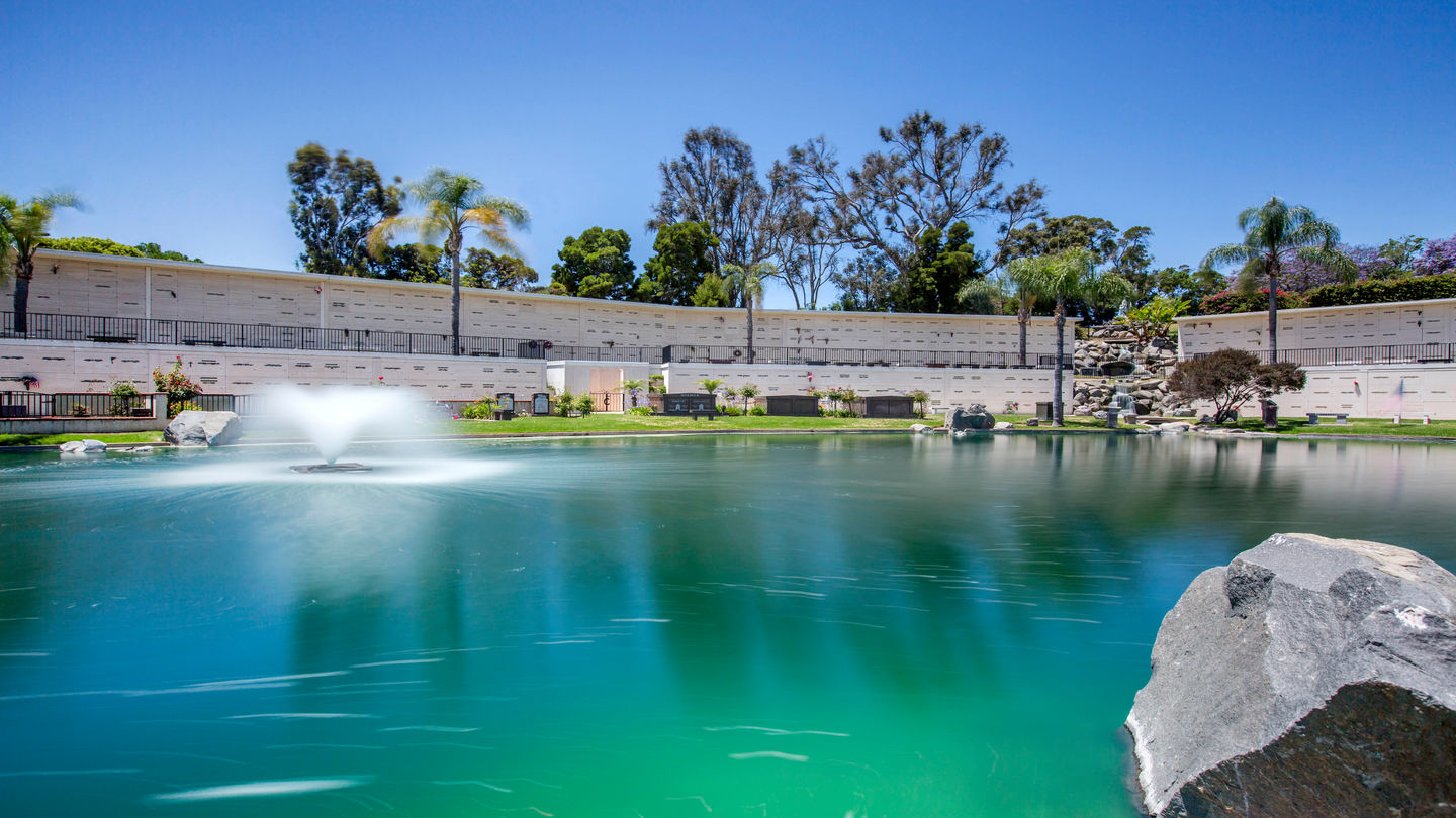 Pond with fountain in front of mausoleum at Eternal Hills Memorial Park. 
