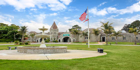 Front exterior view of entrance building with fountain in front at Woodlawn Memorial Park. 