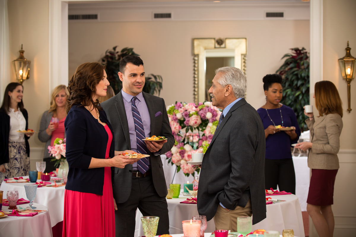 Guests at a memorial reception holding plates of food