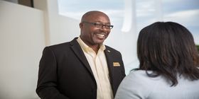 SCI employee talks with a client indoors.