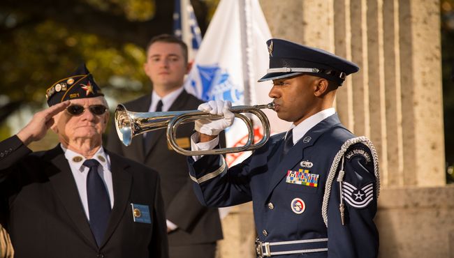 Military Funeral Honors are performed in front of the Armed Forces flags.