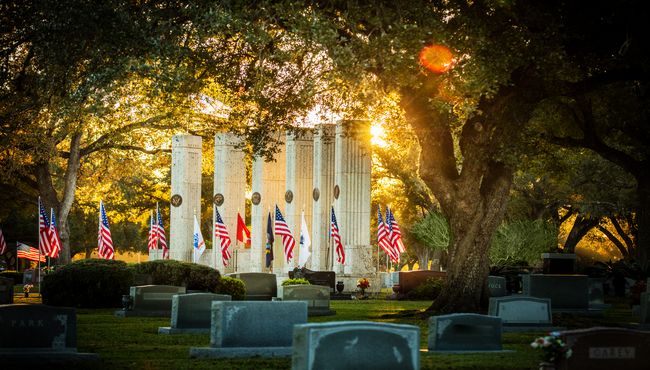 Military Funeral Honors are performed in front of the Armed Forces flags.