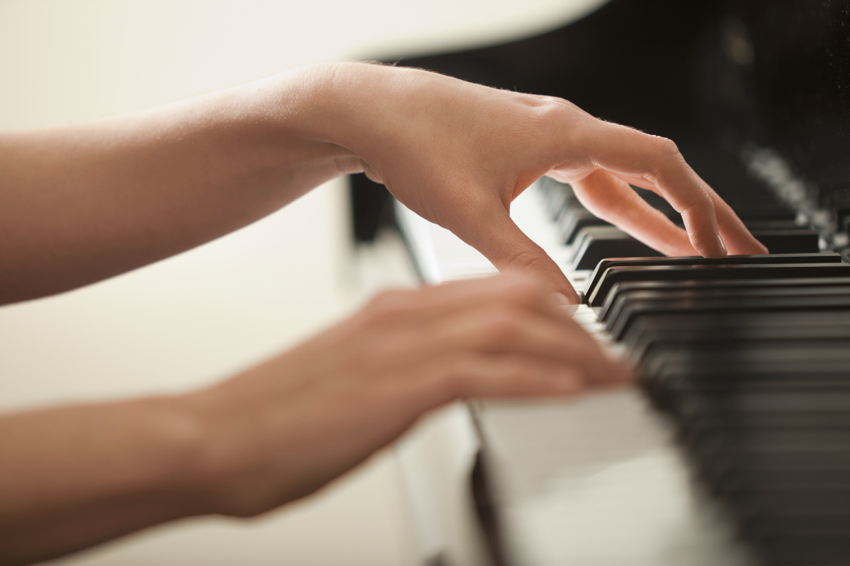 Hands playing the piano