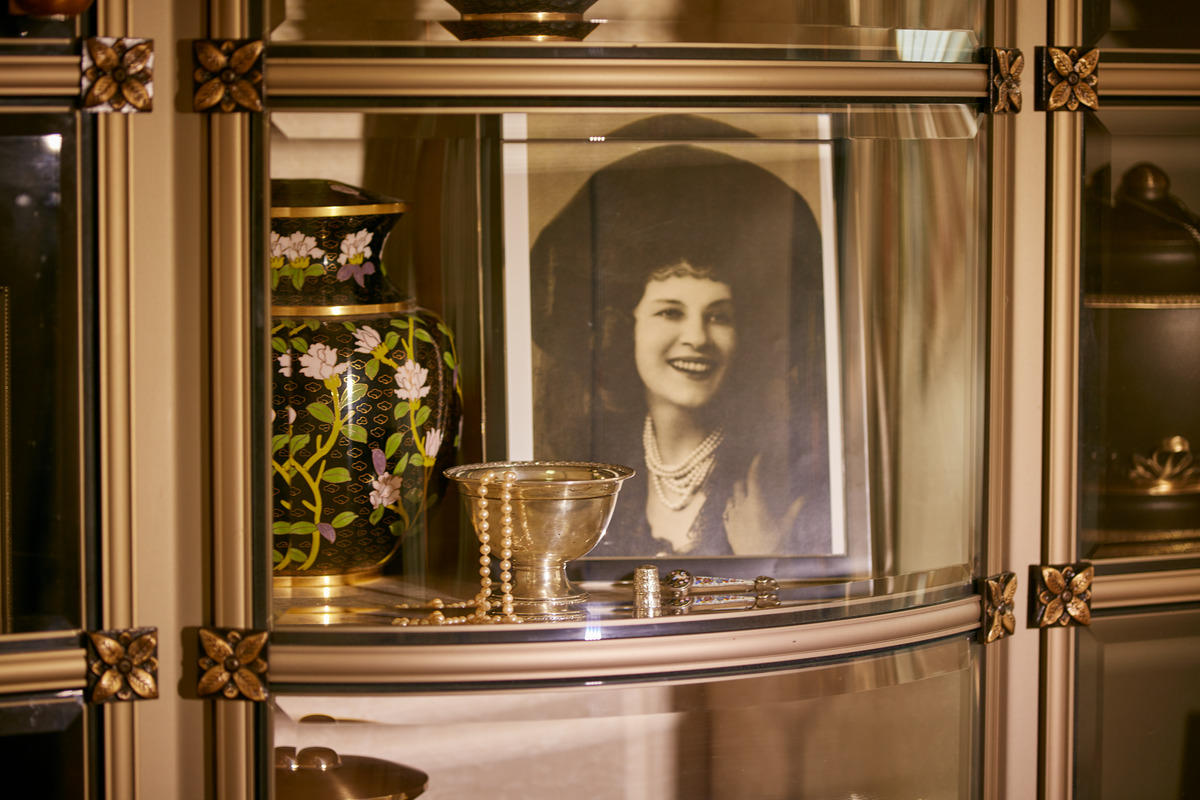 Glass-front niche containing an urn, peals and photograph at Ocean View Funeral Home and Burial Park.