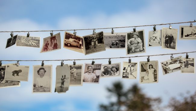 Vintage photographs hanging from a clothesline evoke memories of lives well lived. 
