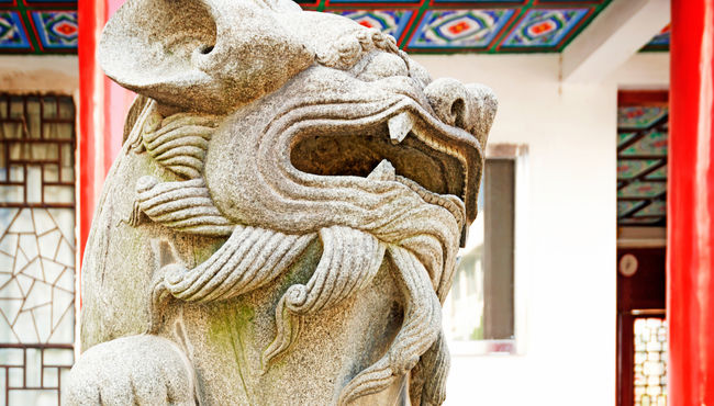 Image of lion statute outside building  used for marketing materials for the traditional Chinese holiday Ching Ming.