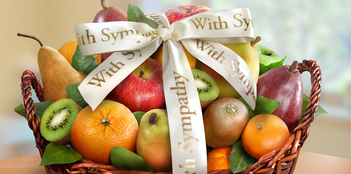 A sympathy gift basket with various fruits.