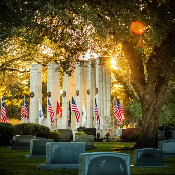 Military Funeral Honors are performed in front of the Armed Forces flags