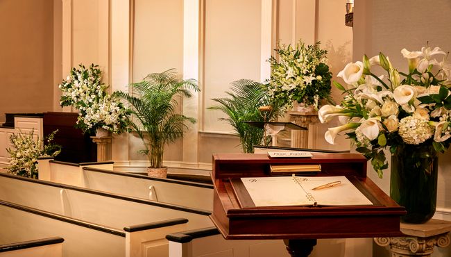 Inside of a chapel looking towards the front of the room.