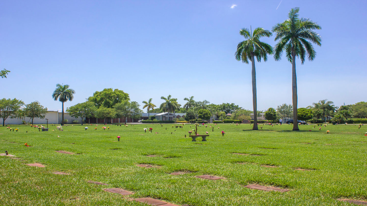 Cemetery grounds with mausoleum in the back at Forest Lawn Memorial Gardens.
