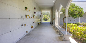 Covered mausoleum exterior with benches at Forest Lawn Memorial Gardens. 