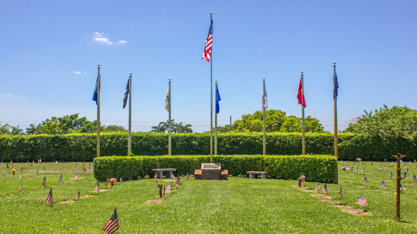 Veteran flags in a row in the cemetery grounds at Forest Lawn Memorial Gardens.