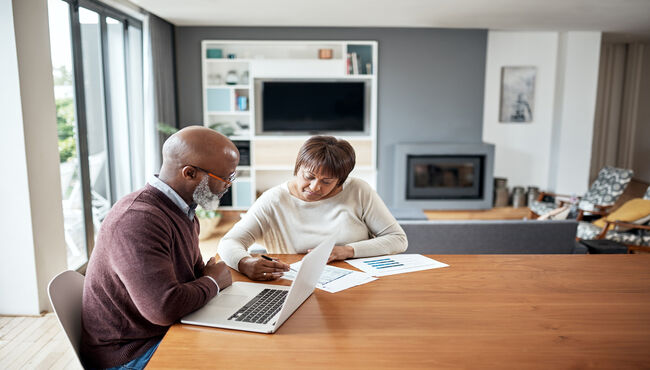 couple sitting at table reviewing paperwork
