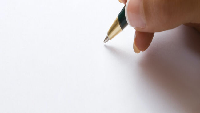 close up of pen writing on paper