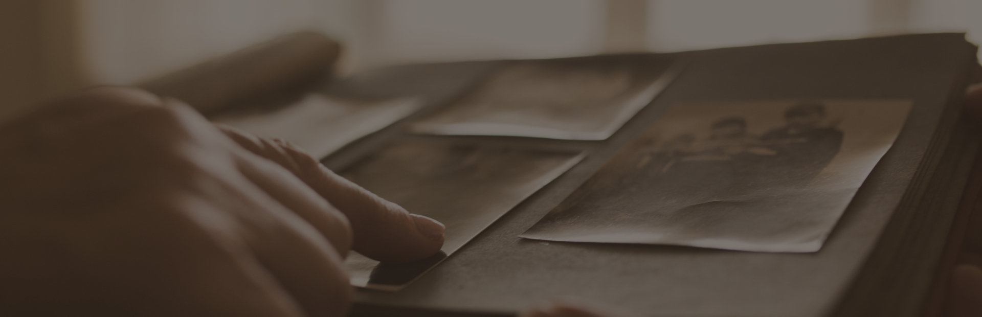 Finger pointing at photo album