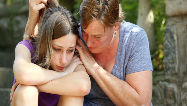 Mother consoling dejected daughter
