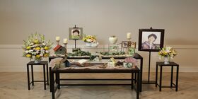 A Memory Table is decorated with pictures and memorabilia, honoring a woman at her celebration of life