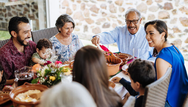 Latin family eating around table