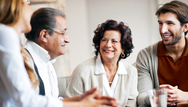 Parents and their adult children sit and talk