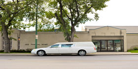 Front exterior building and hearse at Lee Funeral Home and Crematorium
