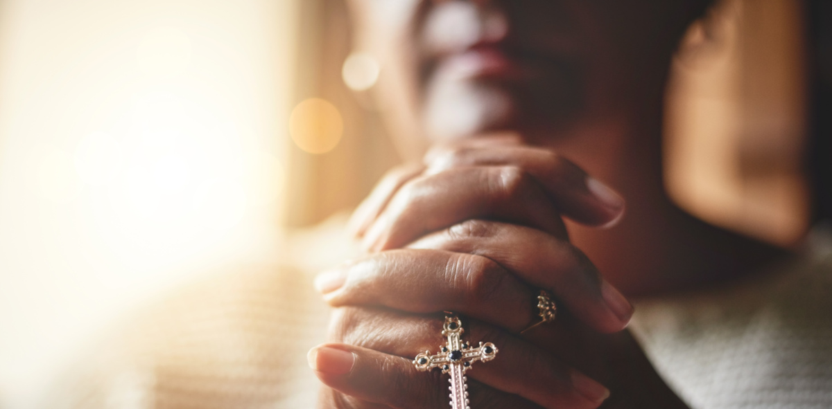 Woman praying with blurred background