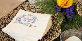 Custom cocktail napkins are printed with a custom phrase and loved one's name