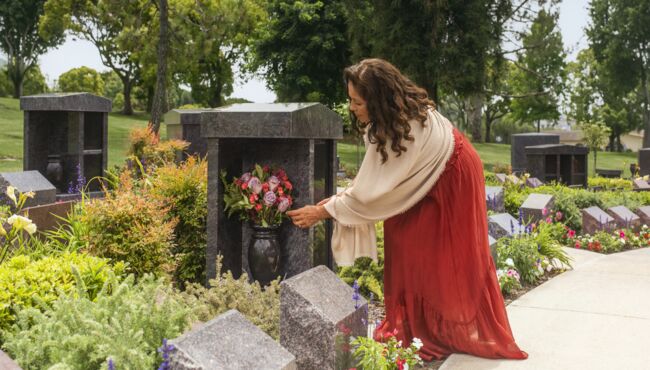 A woman visiting a columbarium of a loved one.