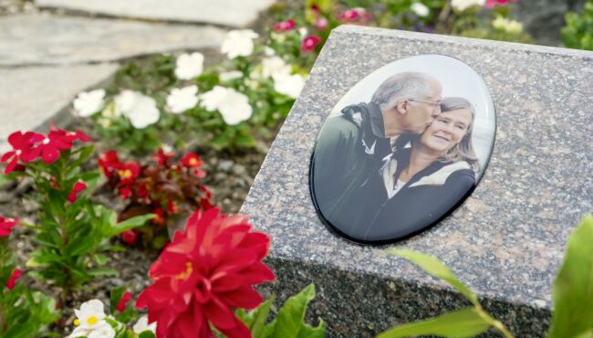 Scenic walkway through the cremation garden with a memorial portrait slanted marker.