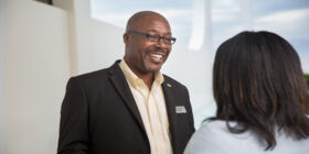 SCI employee talks with a client indoors.