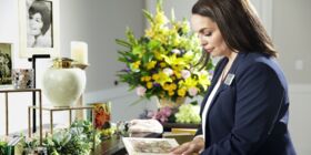 A female Dignity Memorial associate decorates a Memory Table for a celebration of life
