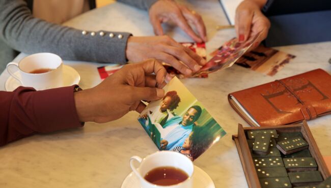 Family and funeral director reminiscing through loved ones photos and memorabilia
